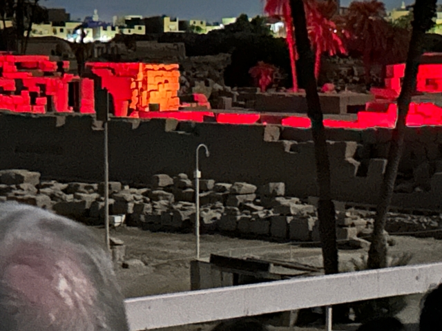 Blurred image of ruins with red lighting.