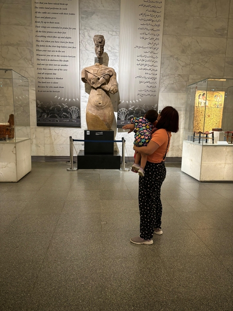 Person viewing an exhibit in a museum.
