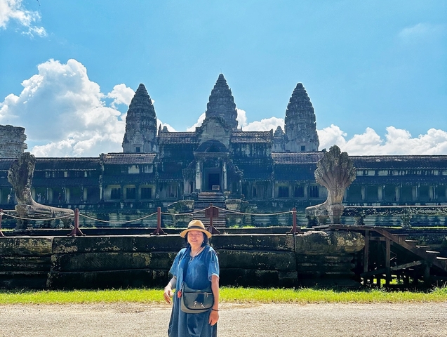 Person in front of Angkor Wat temple.
