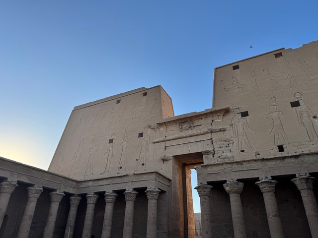 Ancient Egyptian temple with carvings on the exterior.