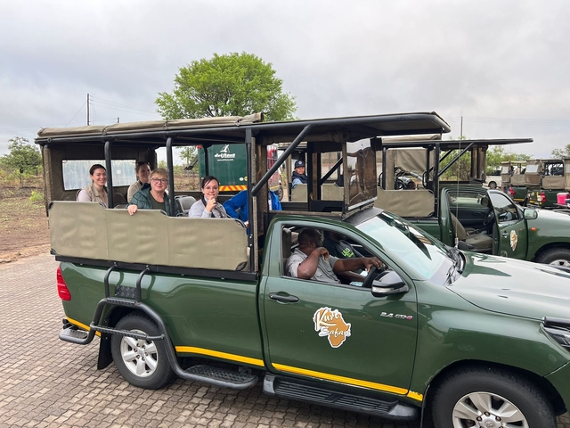 Tourists in an open-air safari vehicle.