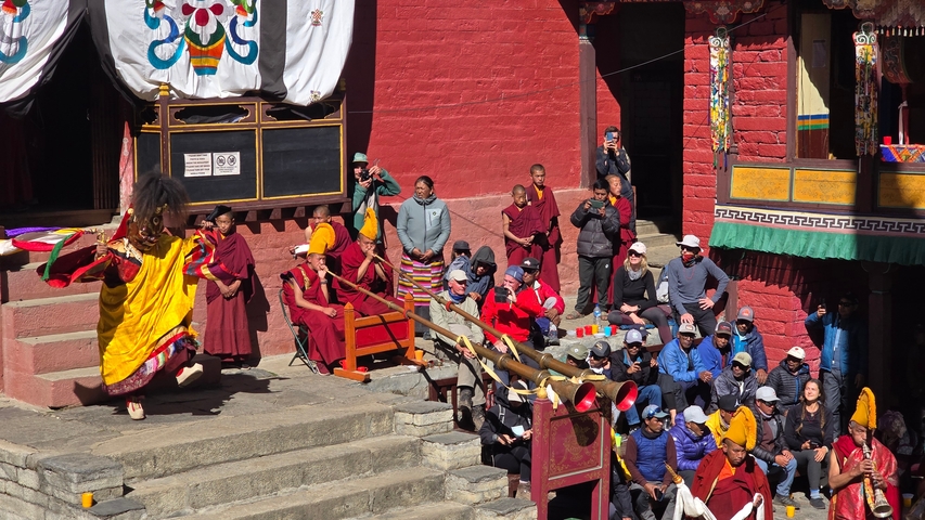 Cultural performance at a traditional temple with an audience.