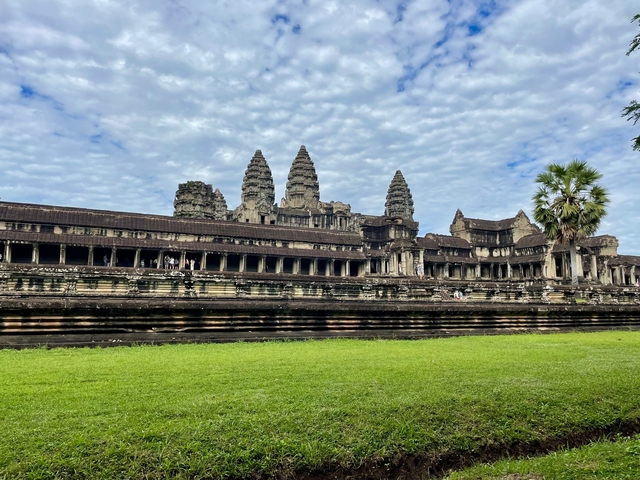      Angkor Wat temple complex with blue sky.
  