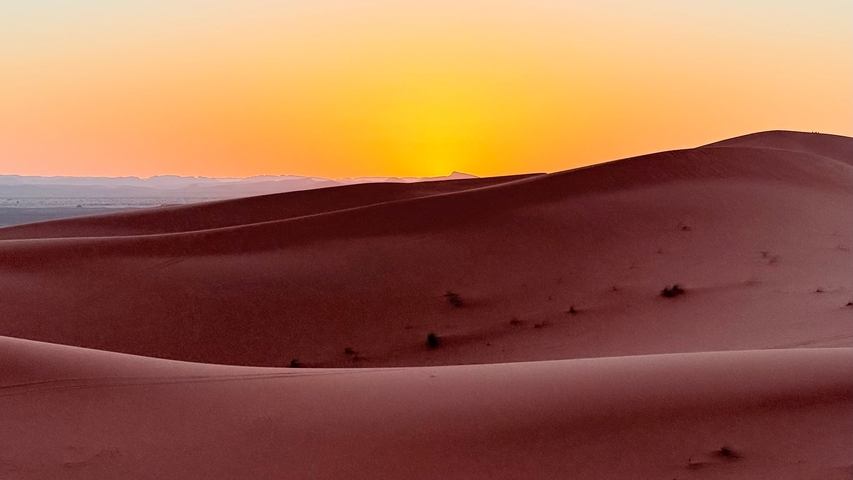       Sunset over the sand dunes.
  