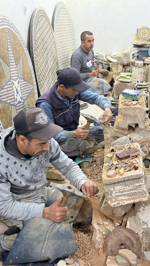       Artisan working with tiles.
  