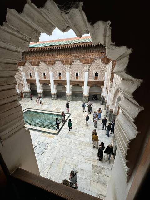       Outdoor courtyard with intricate design and pool.
  
