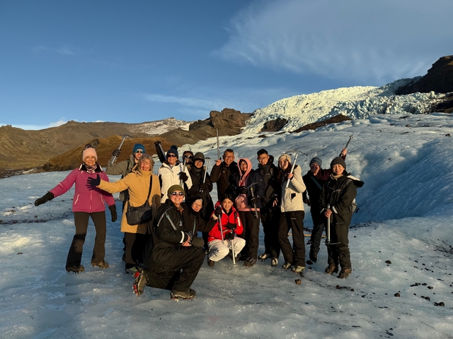       Group of people with winter gear on a glacier.
  