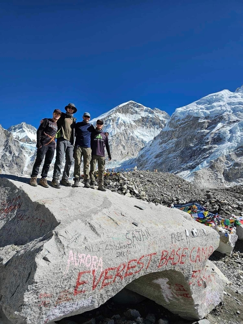 Hikers standing with a snowy Everest backdrop.