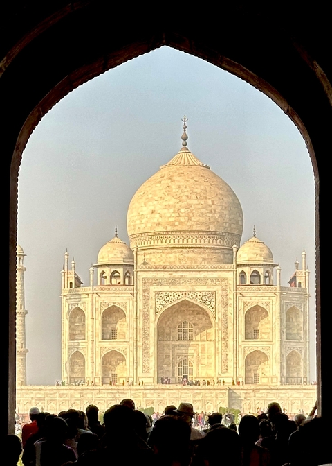 A view of the Taj Mahal through an archway.