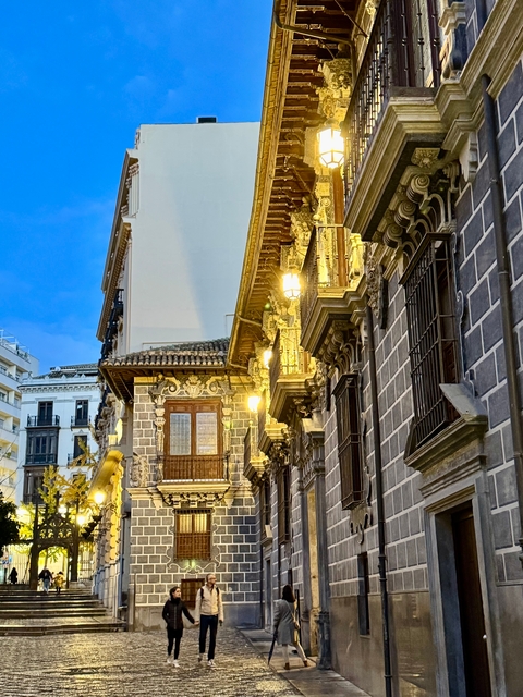 Ornate architecture of a historic building lit at dusk.