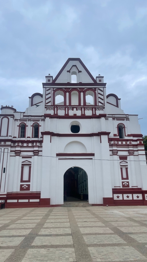       A large white colonial-style church.
  