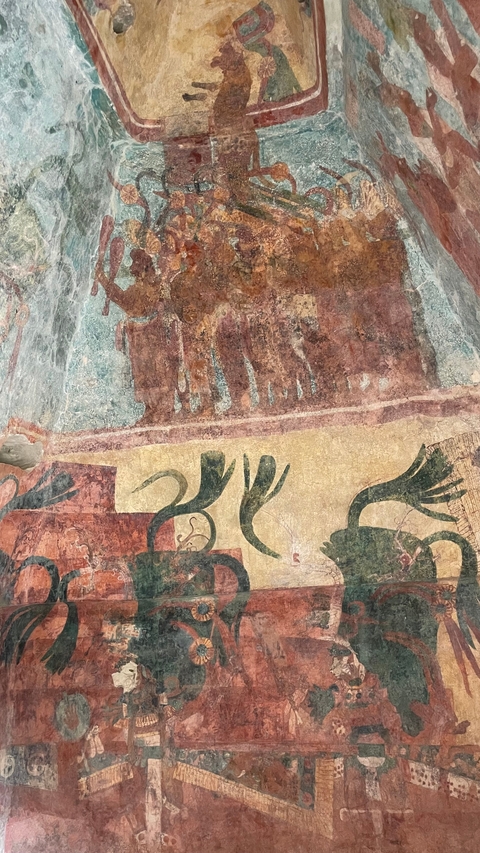       Ancient mural with detailed carvings and figures.
  