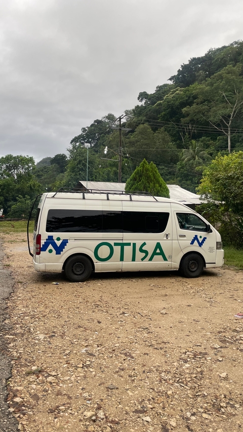       Parked white van with 'OTISA' branding.
  