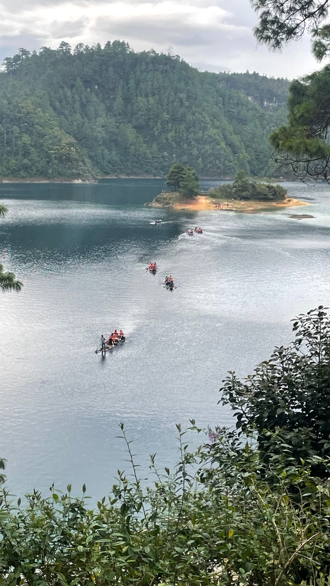       Kayakers paddling on a tranquil lake.
  