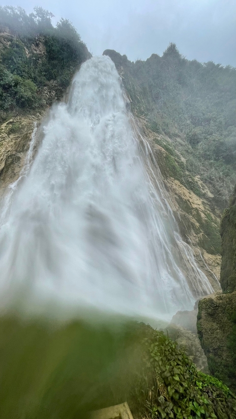       A massive waterfall cascading down a cliff.
  