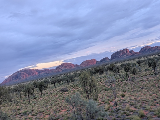       Distant view of rock formations across a wide landscape.
  
