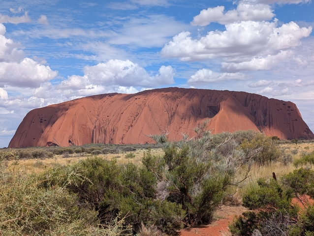       Uluru rock formation under a blue sky.
  