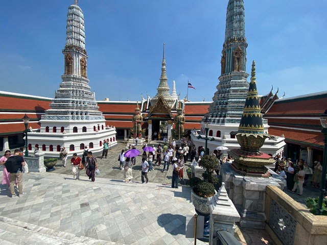       Temple complex with ornate spires and people.
  
