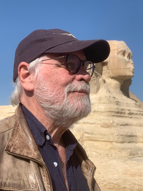 A person with sunglasses in front of the Sphinx.
