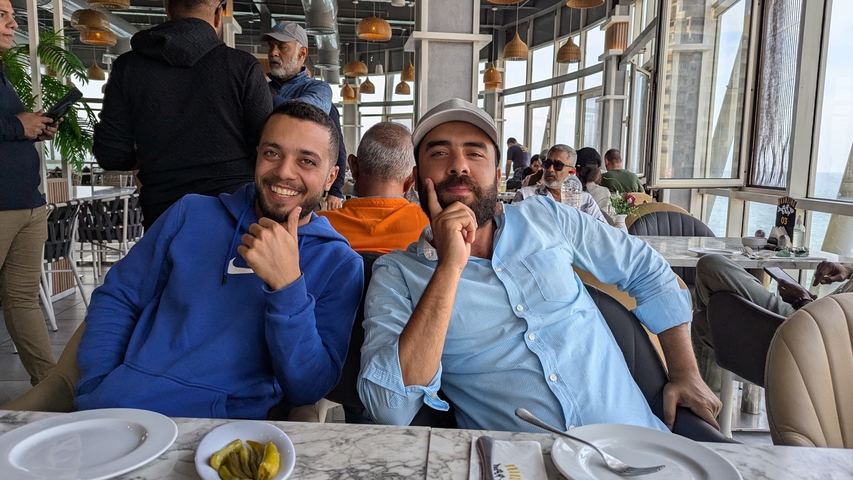 Two people in a bright cafe or restaurant setting.