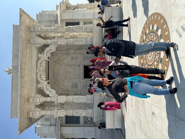 Tourists gathered in front of a grand temple facade.