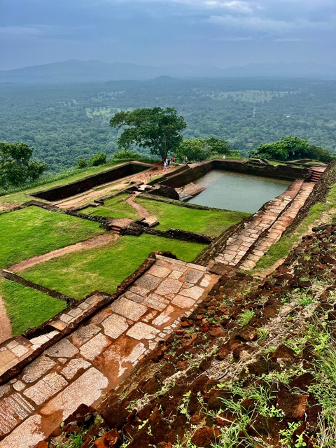 Ancient ruins with elevated view of surrounding forest.