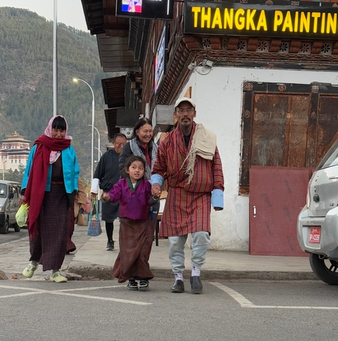       Bhutanese family walking on the street.
  