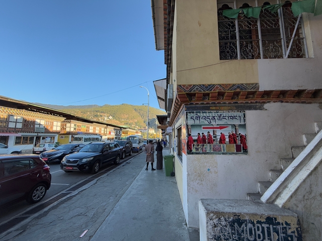       Street scene with traditional buildings and people.
  