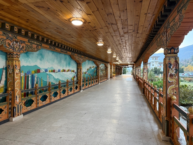       Decorative wooden corridor with murals.
  