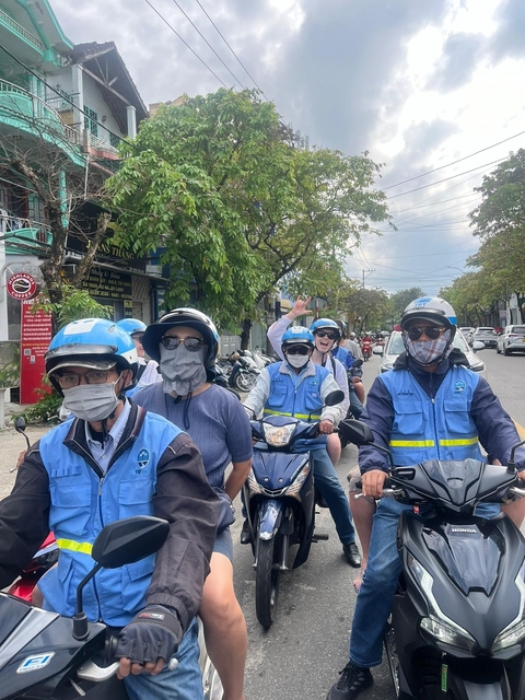       People on motorbikes wearing helmets and masks.
  