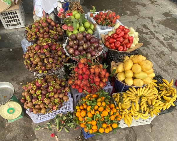       Assortment of colorful fruits in a market setting.
  