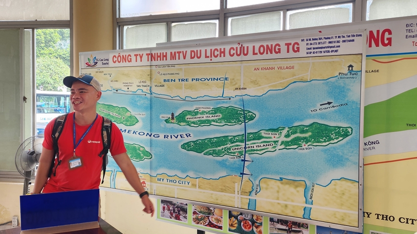       Person standing in front of a map of the Mekong Delta.
  