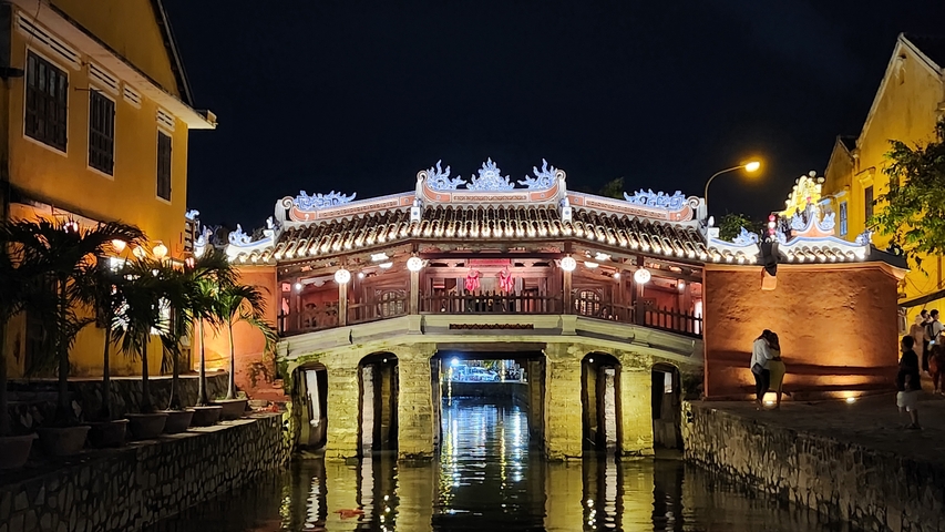       Japanese bridge illuminated at night.
  
