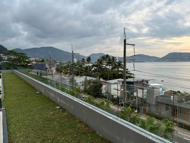 Coastal view of a town with mountains in the background.