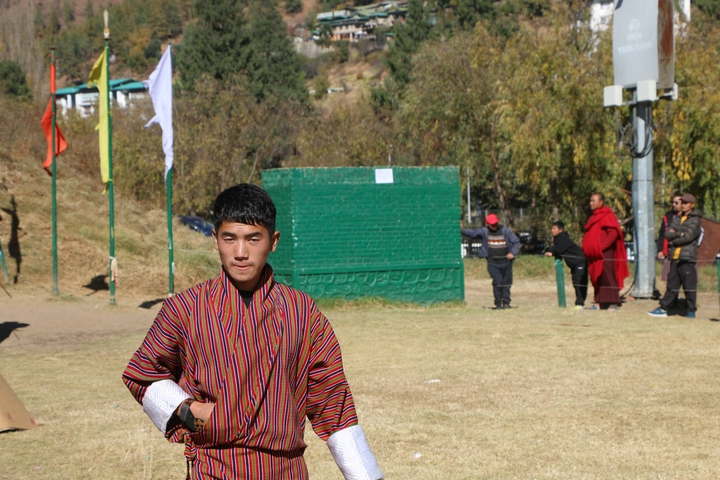       Person outdoors in traditional clothes during the day.
  