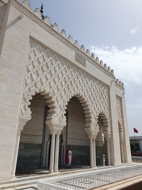 Facade of an ornate building with arches.