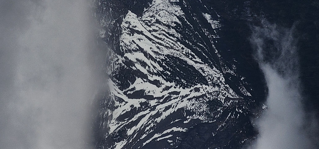       Aerial view of snow-capped mountains.
  