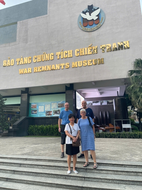 Group of people outside a museum entrance.