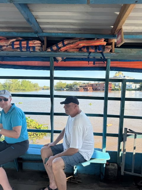 People on a boat enjoying a river view.