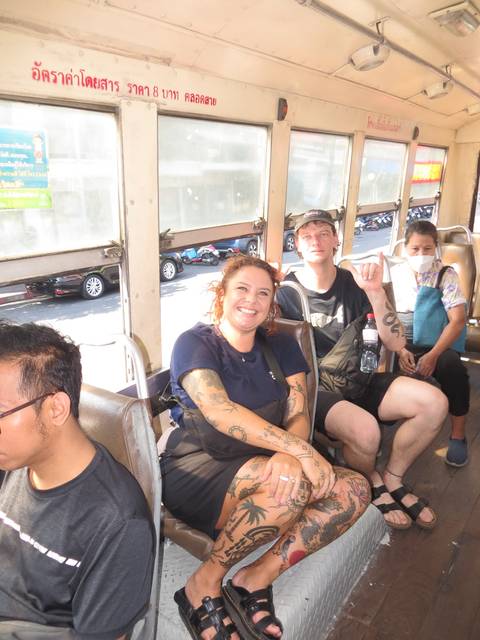 Happy passengers riding in a public bus in an urban setting.