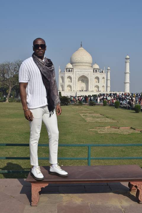       Man posing with the Taj Mahal behind.
  