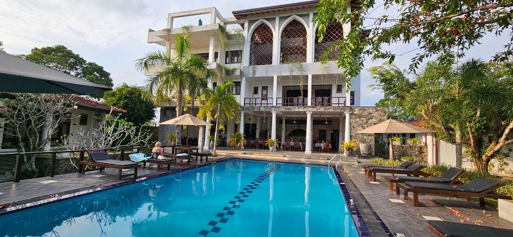       Resort pool area with sun loungers.
  