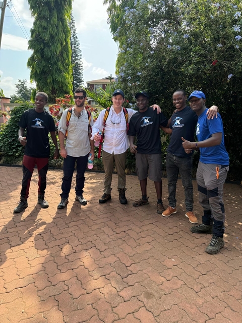       Group of hikers posing in outdoor gear, ready for a trek.
  