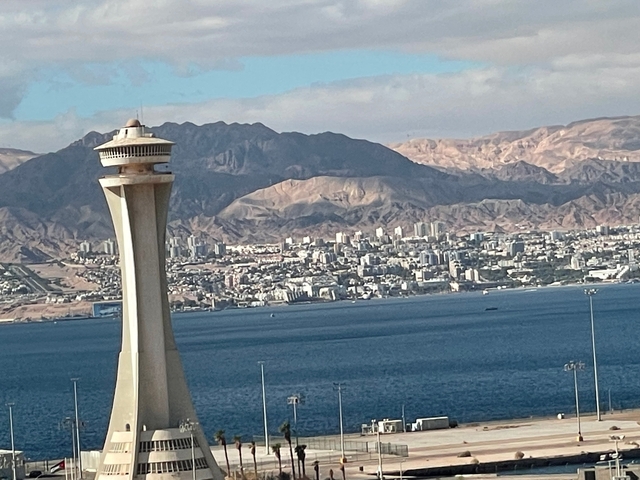       A tower overlooking a city and coast.
  
