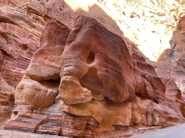       Rock formations with a hole resembling an eye.
  