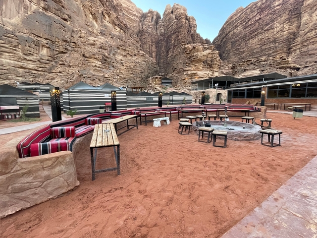       Outdoor seating area in a desert camp.
  