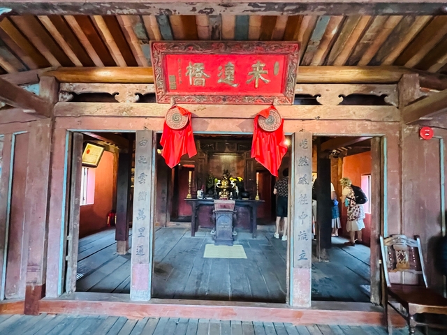       Interior of a traditional building with two people visible.
  