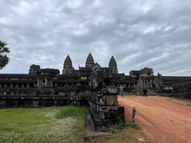       Angkor Wat temple complex with visitors.
  