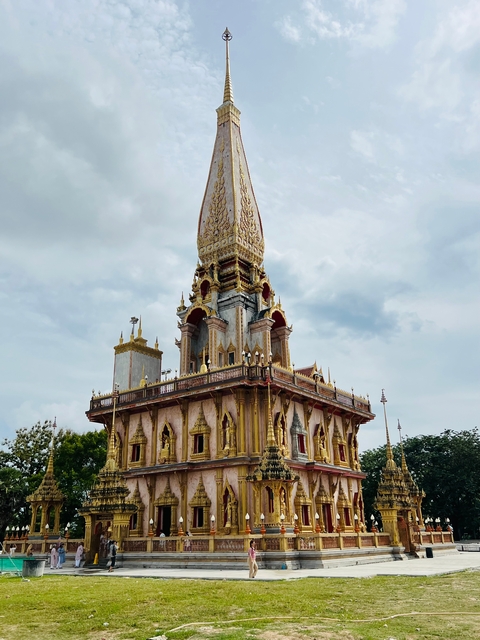       Ornate temple spire against a cloudy sky.
  