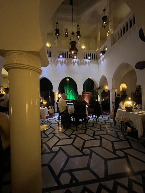 Elegant restaurant interior with people dining.